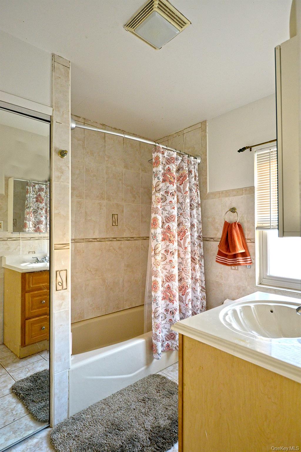 92-49 Springfield Boulevard Queens, NY 11428 - Photo 12 of 17 a bathroom with a tub sink and shower