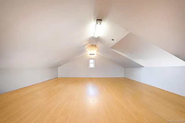 a spacious bedroom with a bed and a potted plant