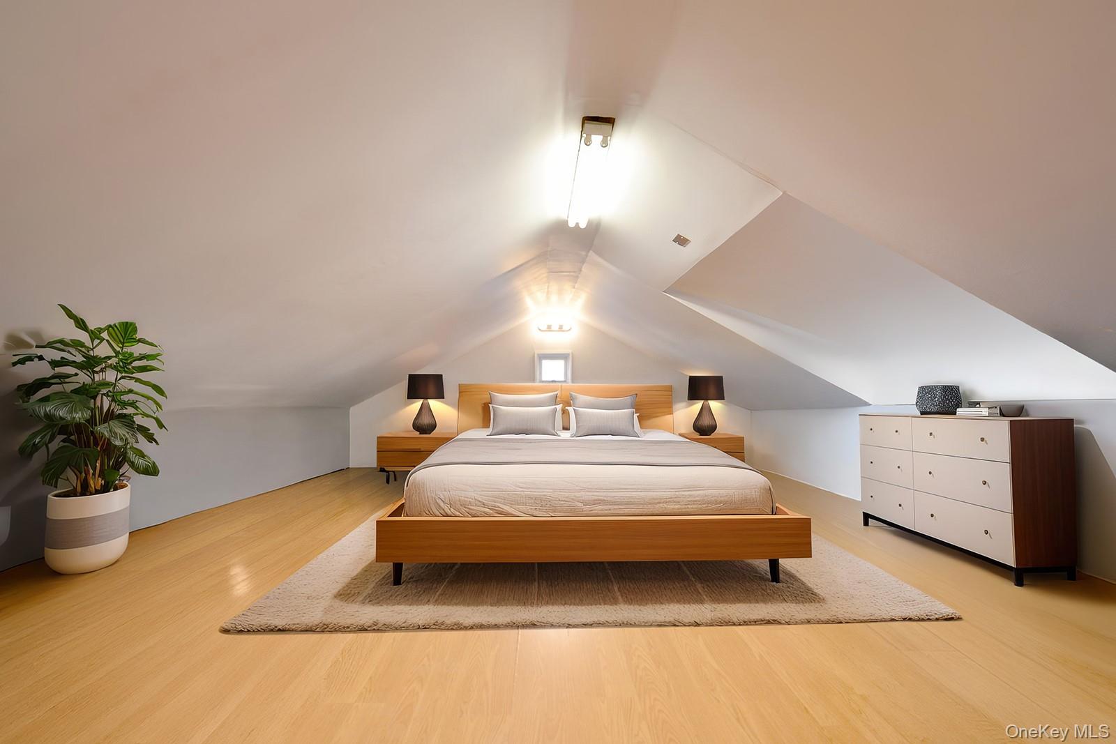 92-49 Springfield Boulevard Queens, NY 11428 - Photo 14 of 17 a spacious bedroom with a bed and a potted plant