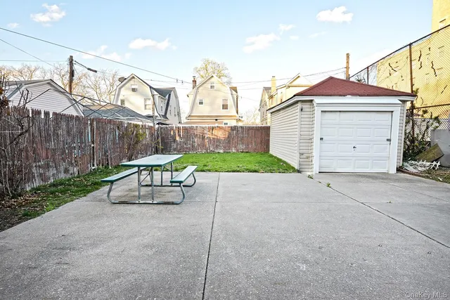 a view of a brick house with a yard and large tree