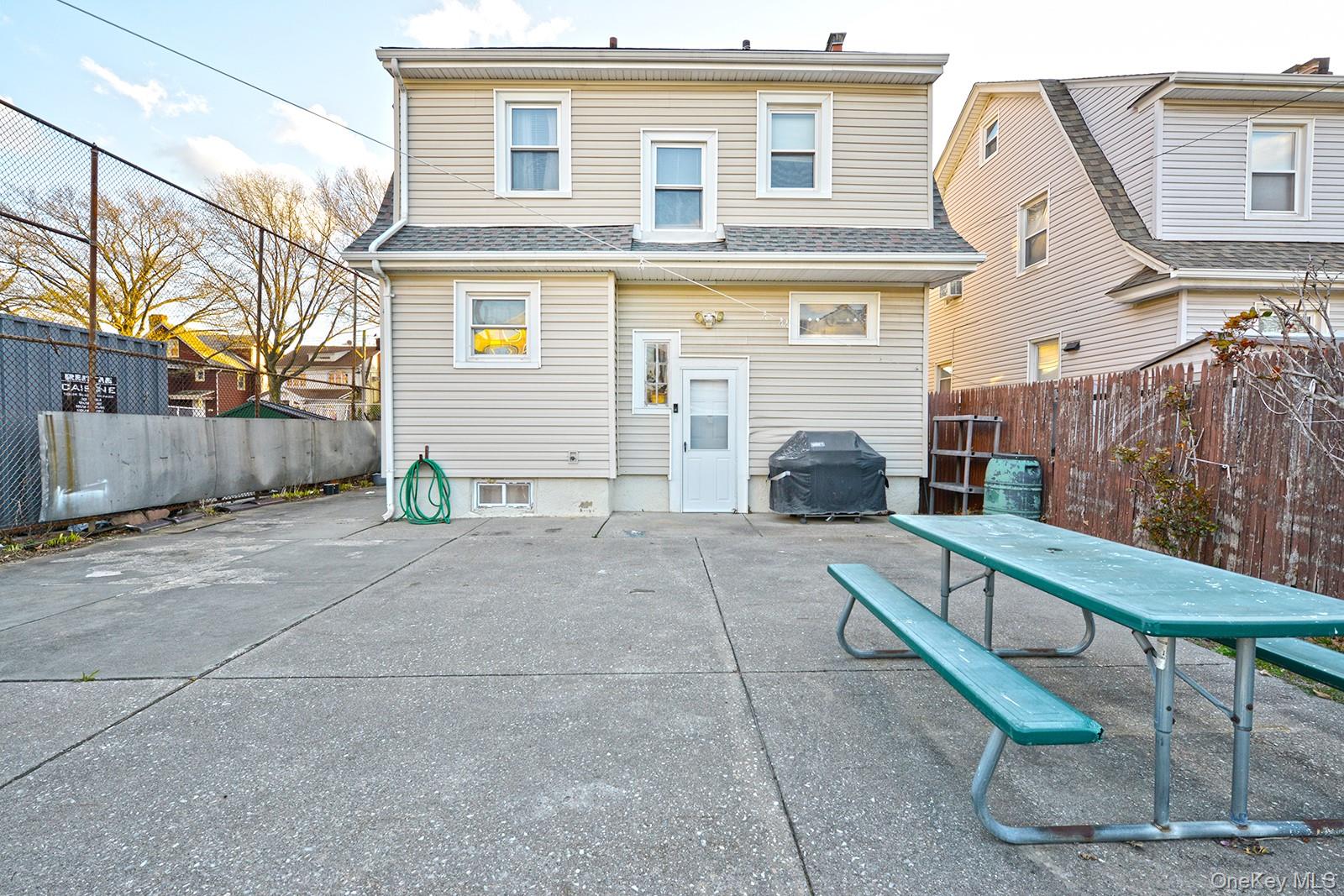 92-49 Springfield Boulevard Queens, NY 11428 - Photo 17 of 17 a view of a brick house with a yard and large tree