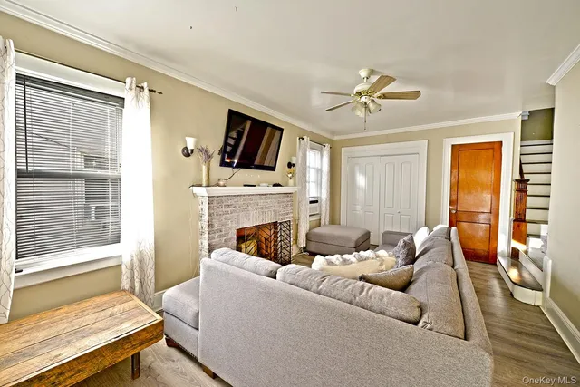 a living room with furniture a fireplace and a flat screen tv