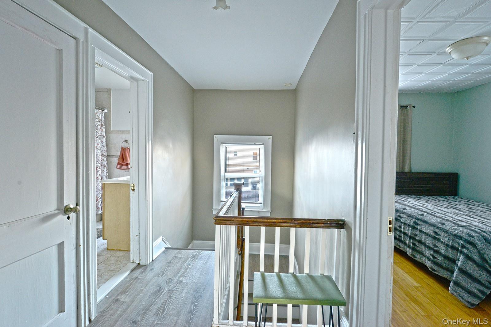 92-49 Springfield Boulevard Queens, NY 11428 - Photo 8 of 17 a view of a hallway with wooden floor and bedroom
