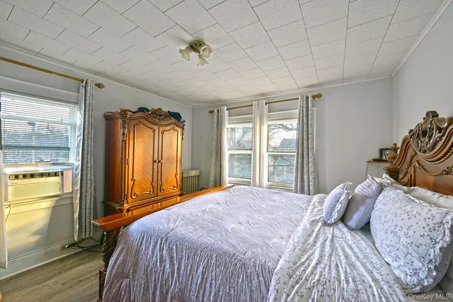 a bedroom with a bed and a window with outer view