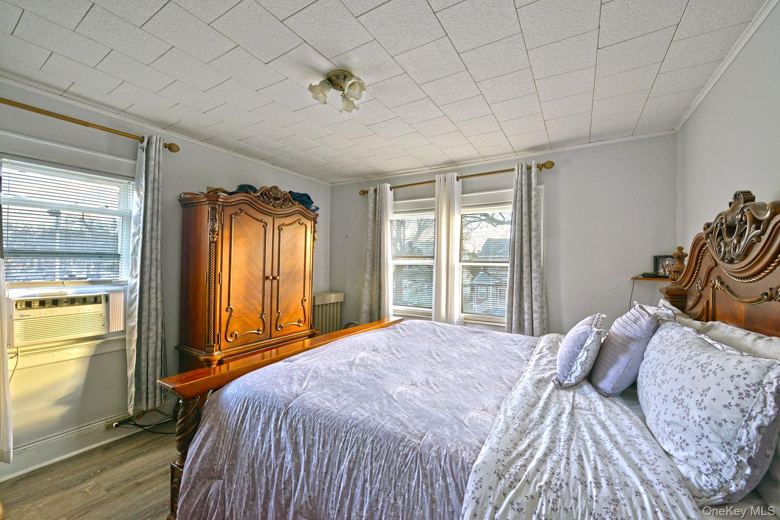 92-49 Springfield Boulevard Queens, NY 11428 - Photo 10 of 17 a bedroom with a bed and a window with outer view