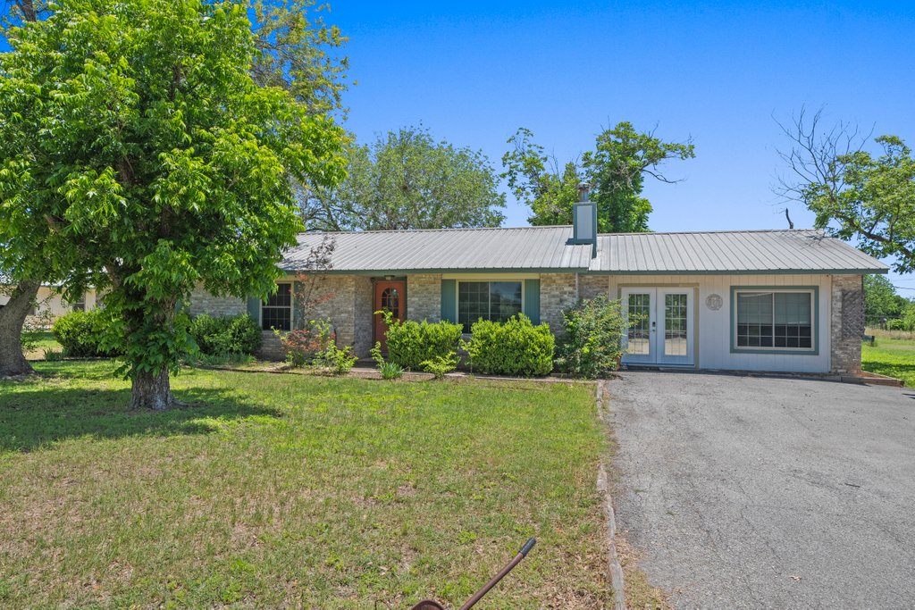 a front view of a house with garden