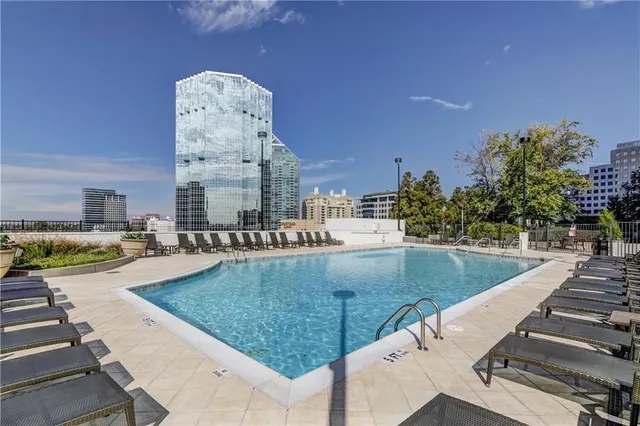 a view of a swimming pool with outdoor seating