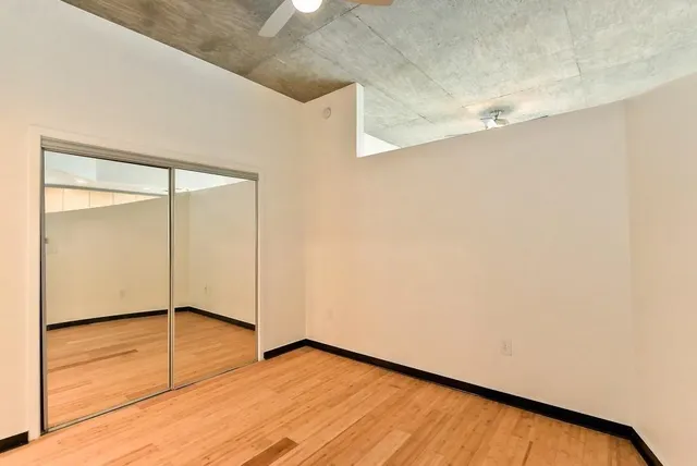 a view of a room with wooden floor