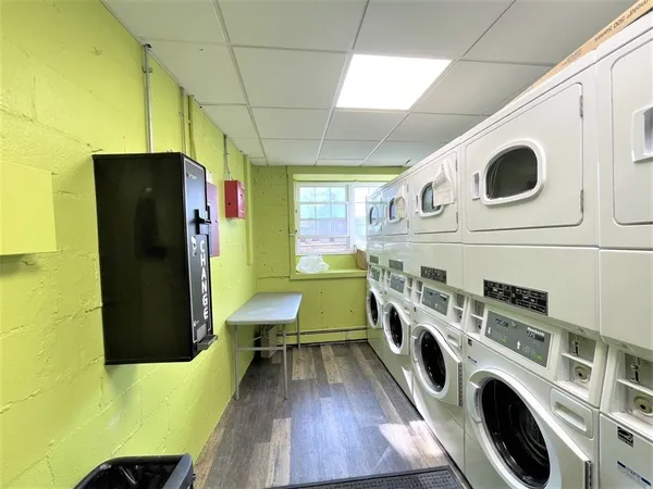 a utility room with dryer washer and a refrigerator
