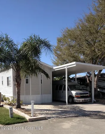 a view of a wooden deck and a yard with lake view