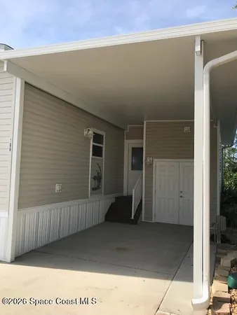 a view of a house next to a yard