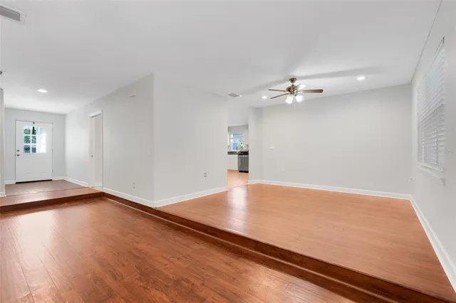 wooden floor in an empty room with a window