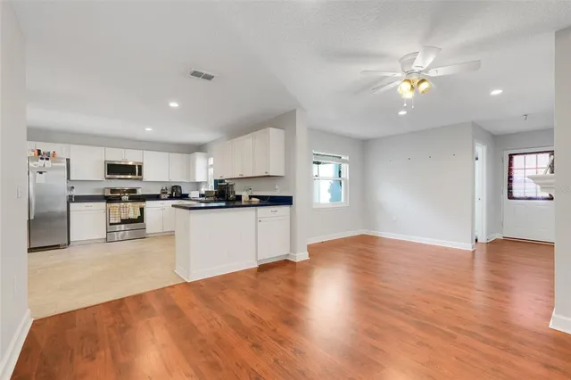 a view of kitchen with refrigerator and microwave