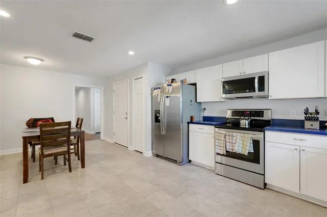 a kitchen with stainless steel appliances granite countertop a stove and a refrigerator