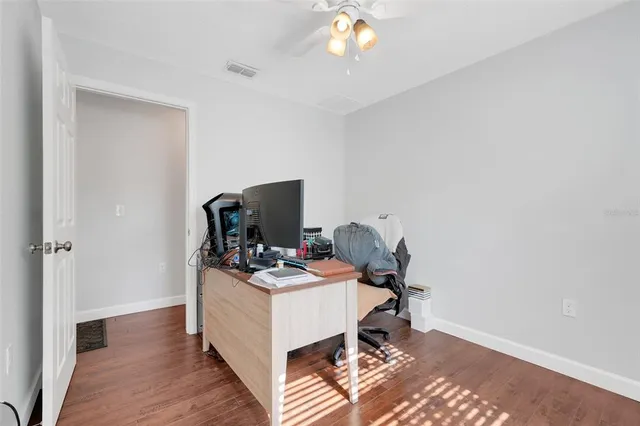 a view of a workspace with furniture and a window