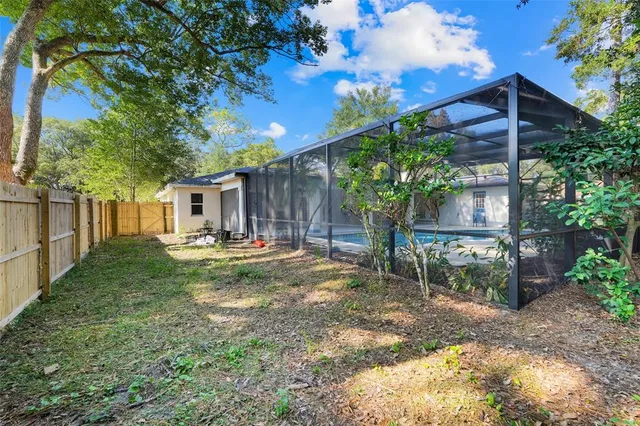 a view of house with backyard and sitting area