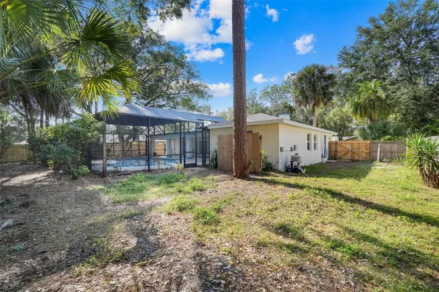 a backyard of a house with a garden and outdoor seating