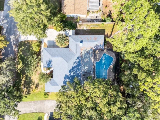 an aerial view of a house with a yard