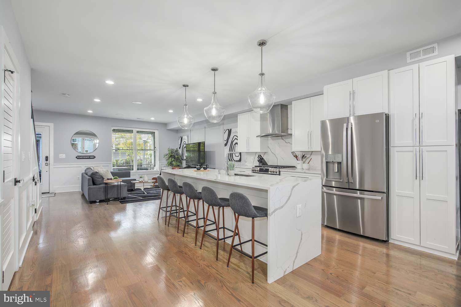 1427 Perry Place Northwest Washington, DC 20010 - Photo 11 of 40 a kitchen with stainless steel appliances granite countertop a refrigerator a sink dishwasher a stove and white cabinets with wooden floor