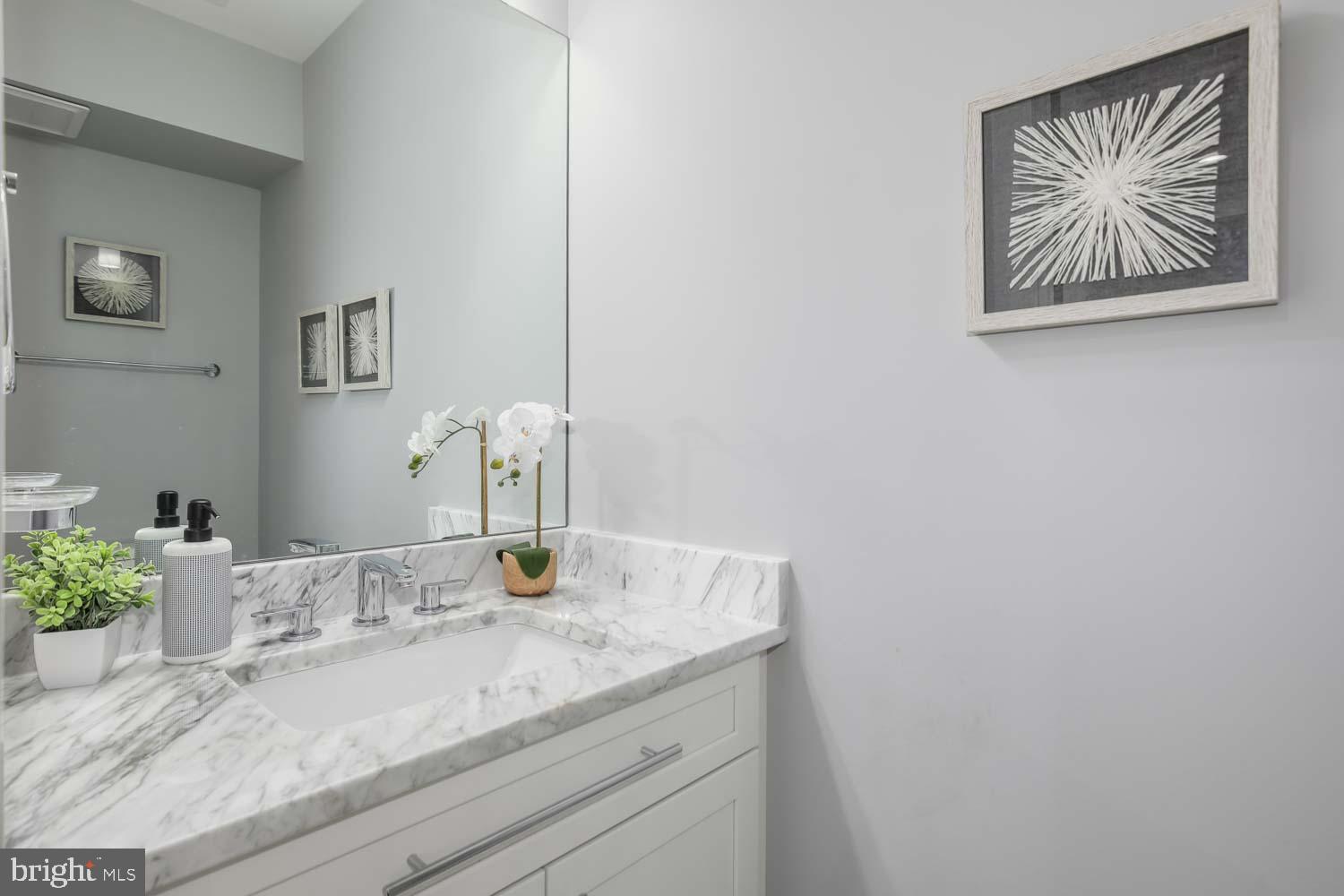1427 Perry Place Northwest Washington, DC 20010 - Photo 12 of 40 a bathroom with a granite countertop sink and a mirror