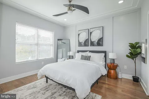 a bedroom with a large bed and a chandelier