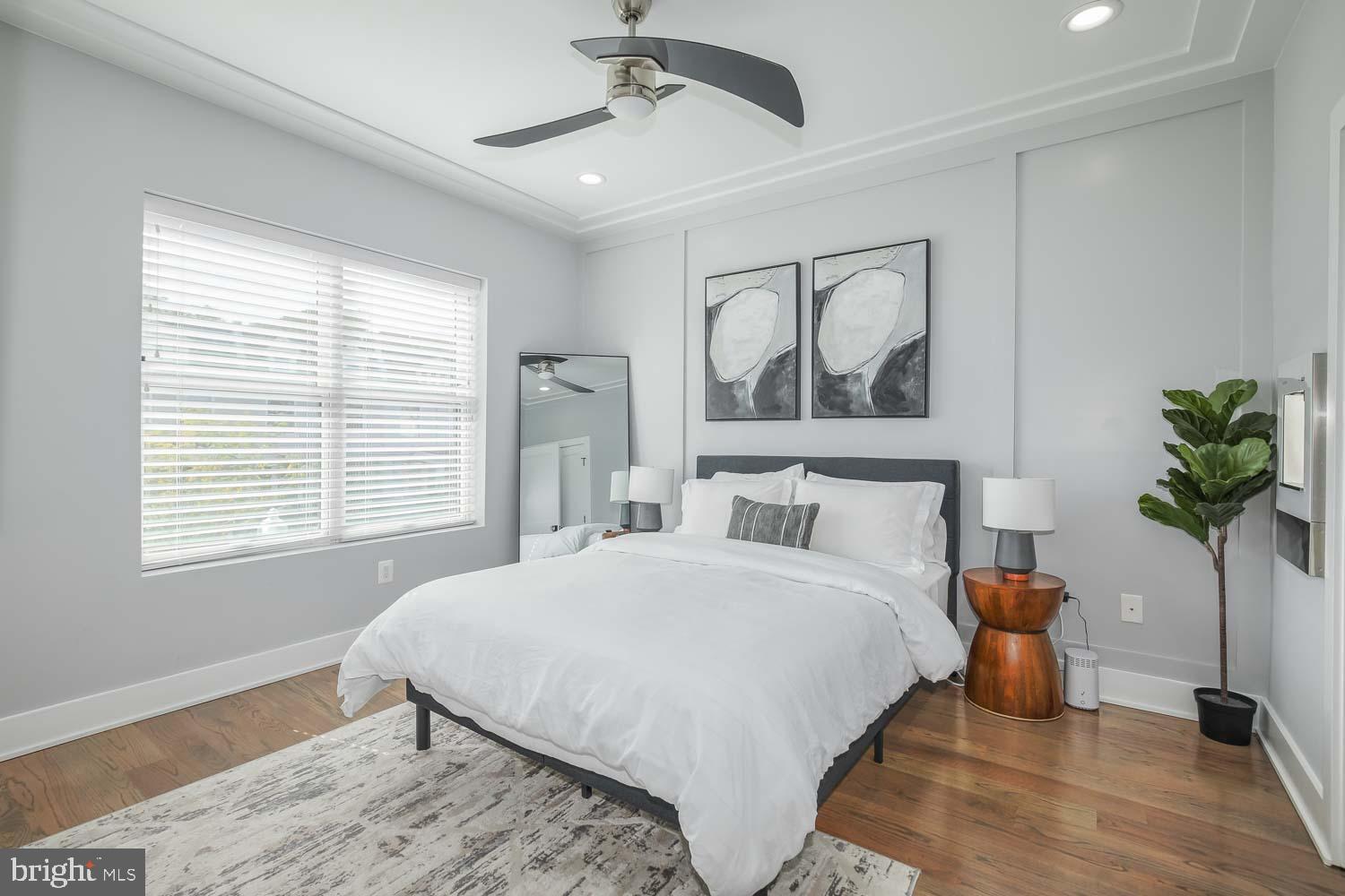 1427 Perry Place Northwest Washington, DC 20010 - Photo 13 of 40 a bedroom with a large bed and a chandelier