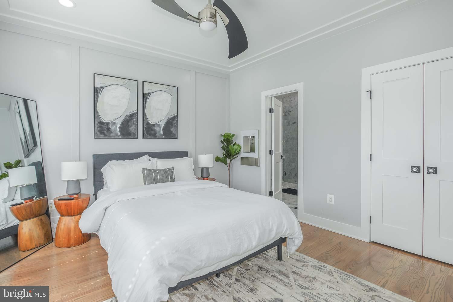 1427 Perry Place Northwest Washington, DC 20010 - Photo 14 of 40 a bedroom with a bed and wooden floor