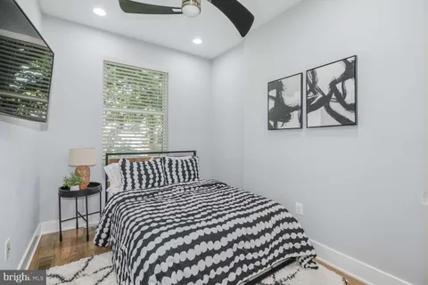 a bedroom with a bed and a painting on the wall