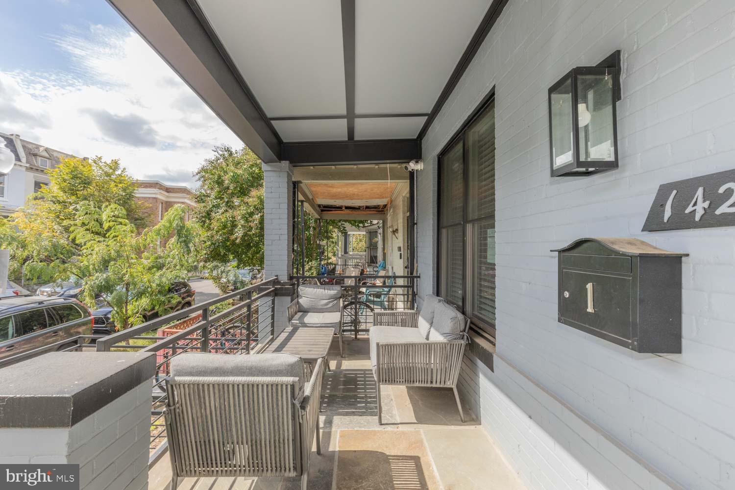 1427 Perry Place Northwest Washington, DC 20010 - Photo 2 of 40 a dining room with furniture and a floor to ceiling window