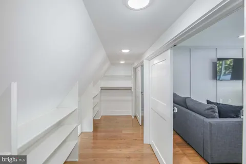 a living room with furniture and a walk in closet