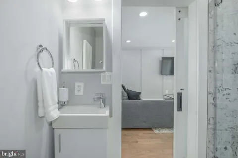 a bathroom with a sink a toilet and shower