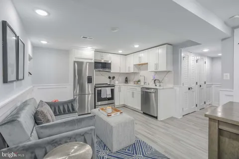 a living room with furniture and kitchen view