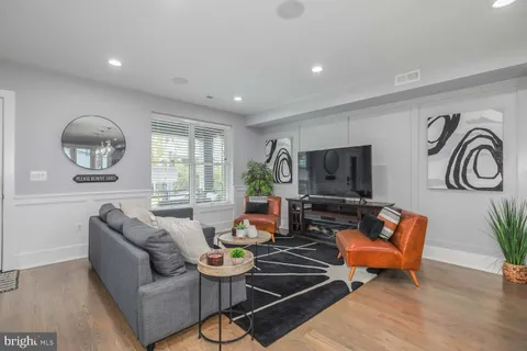 a living room with furniture and wooden floor