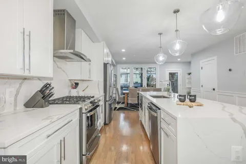 a kitchen with stainless steel appliances a stove sink and cabinets