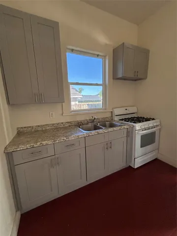 a kitchen with a stove a sink and a microwave