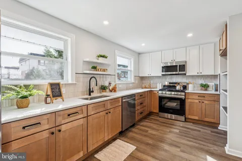 a kitchen with sink a microwave and cabinets