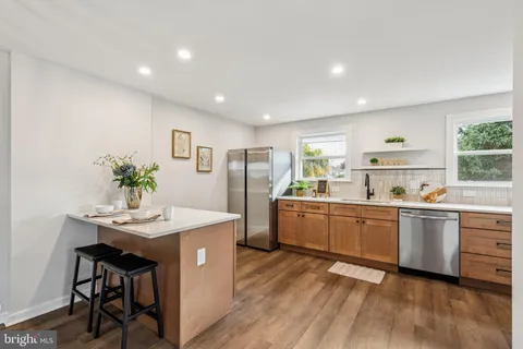 a kitchen with refrigerator and cabinets