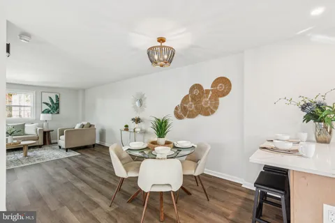 a dining room with furniture a rug and wooden floor