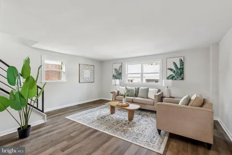 a living room with furniture and a potted plant