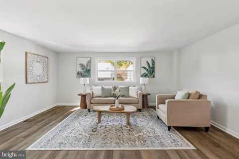 a living room with furniture and a rug