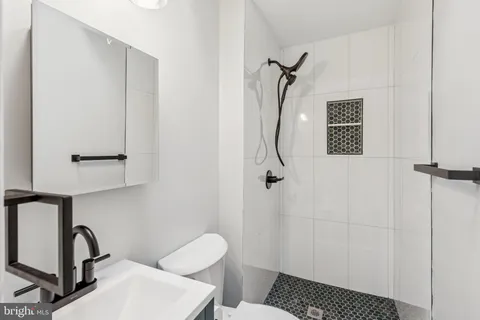 a bathroom with a toilet a sink and shower