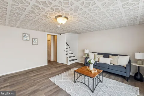 a view of a livingroom with furniture and a potted plant