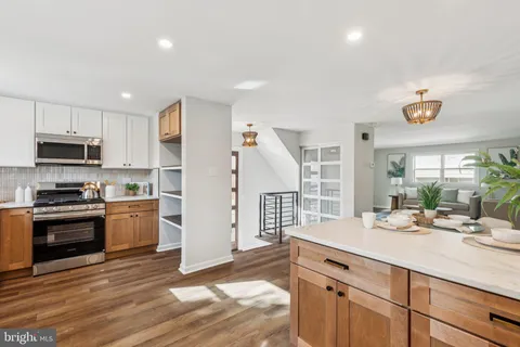 a kitchen with a sink stainless steel appliances and cabinets