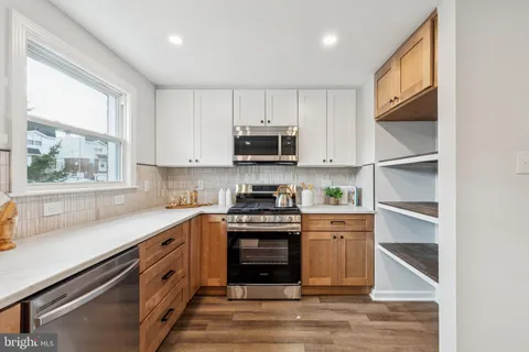 a kitchen with stainless steel appliances granite countertop a stove and a sink