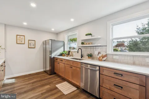 a kitchen with stainless steel appliances a sink a stove and a refrigerator