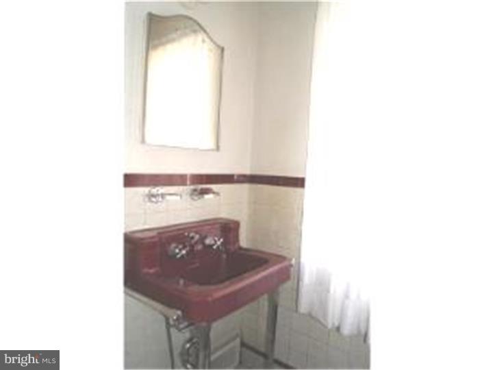1101 East Darby Road Havertown, PA 19083 - Photo 12 of 20 a bathroom with a sink a mirror and a window