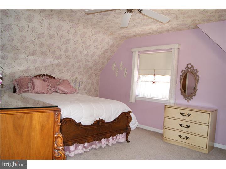 1101 East Darby Road Havertown, PA 19083 - Photo 14 of 20 a bedroom with a bed a dresser and a window