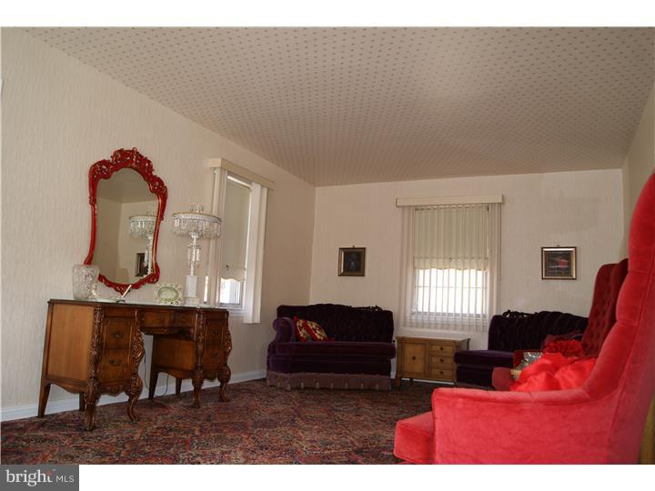 1101 East Darby Road Havertown, PA 19083 - Photo 8 of 20 a living room with furniture a window and bookshelf