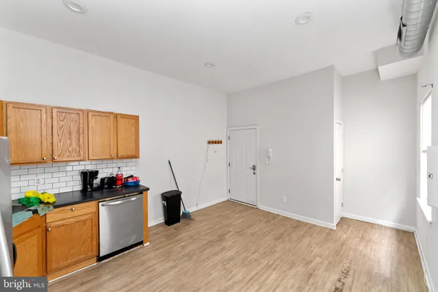 a kitchen with granite countertop a stove and cabinets