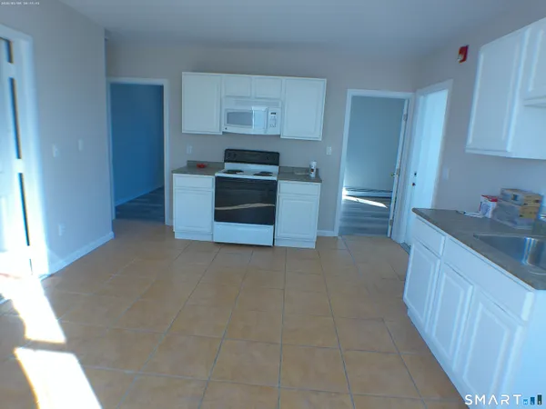 a kitchen with stainless steel appliances granite countertop a stove a refrigerator and a sink